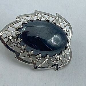 Vintage filigree framed hematite brooch.